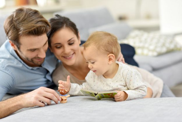 Parents enjoying playing with baby girl